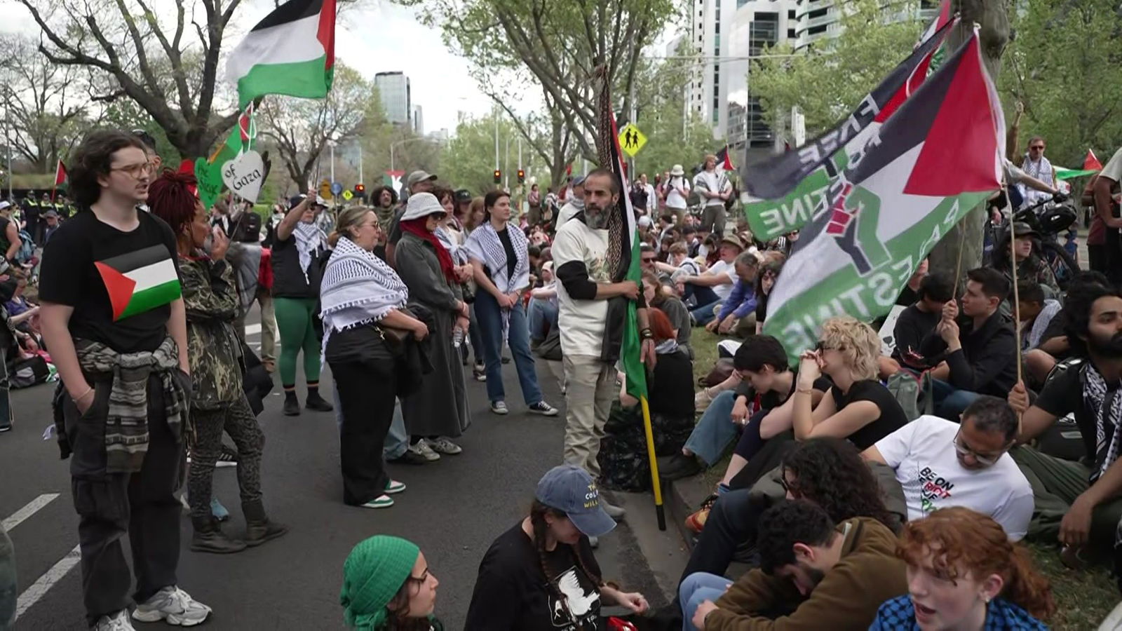 A crowd of protesters holding Palestinian flags
