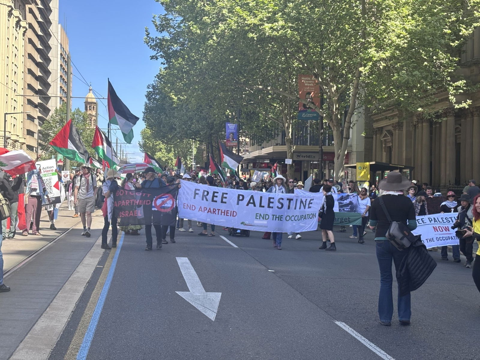 Protesters hold a banner that reads: "FREE PALESTINE, END APARTHEID, END THE OCCUPATION"