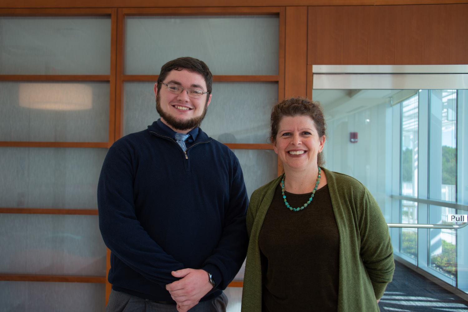 Conner Linehan and Jennifer Stroop stand in front of the Cancer Center