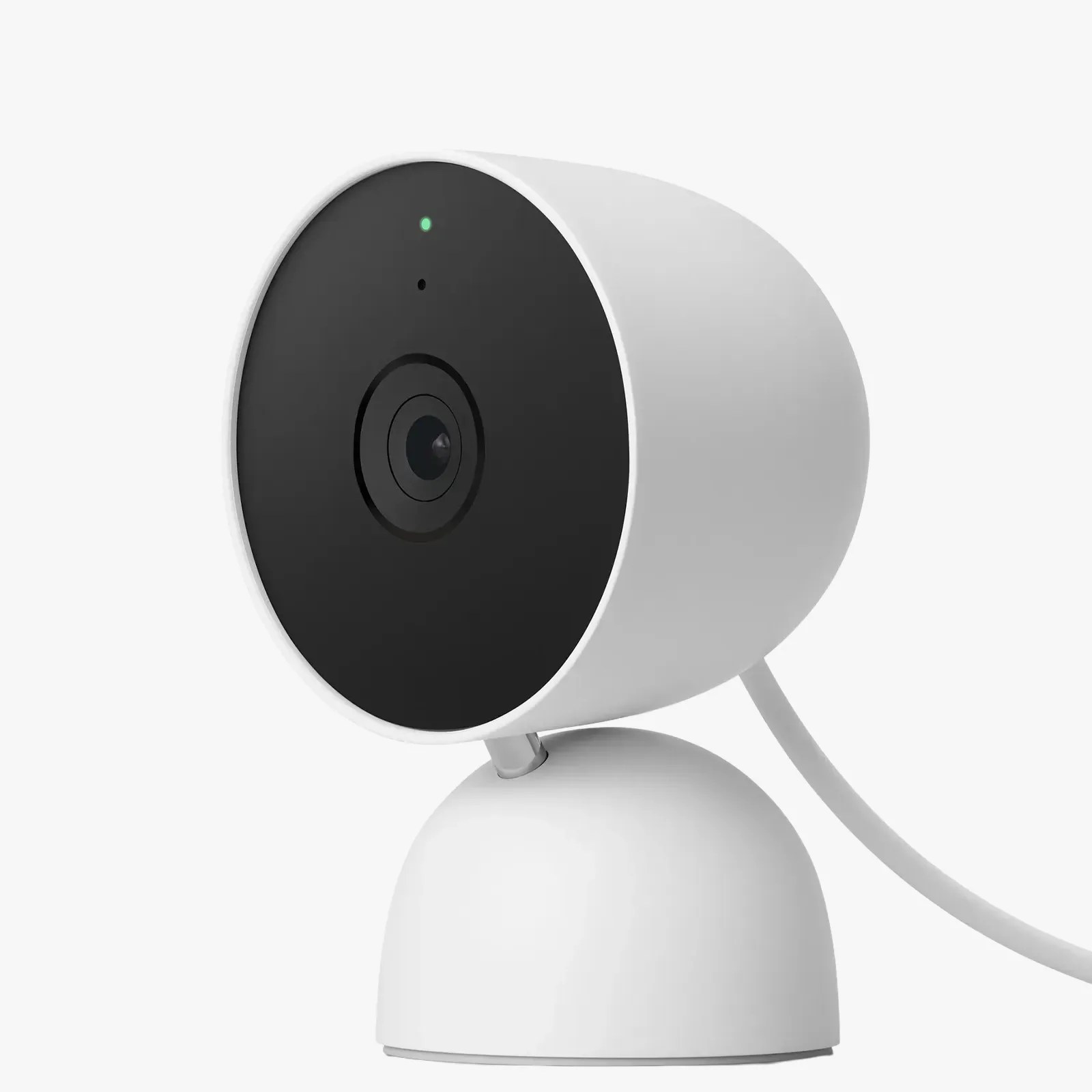 White cylindrical security camera with black front face and green indicator light on a rounded base.