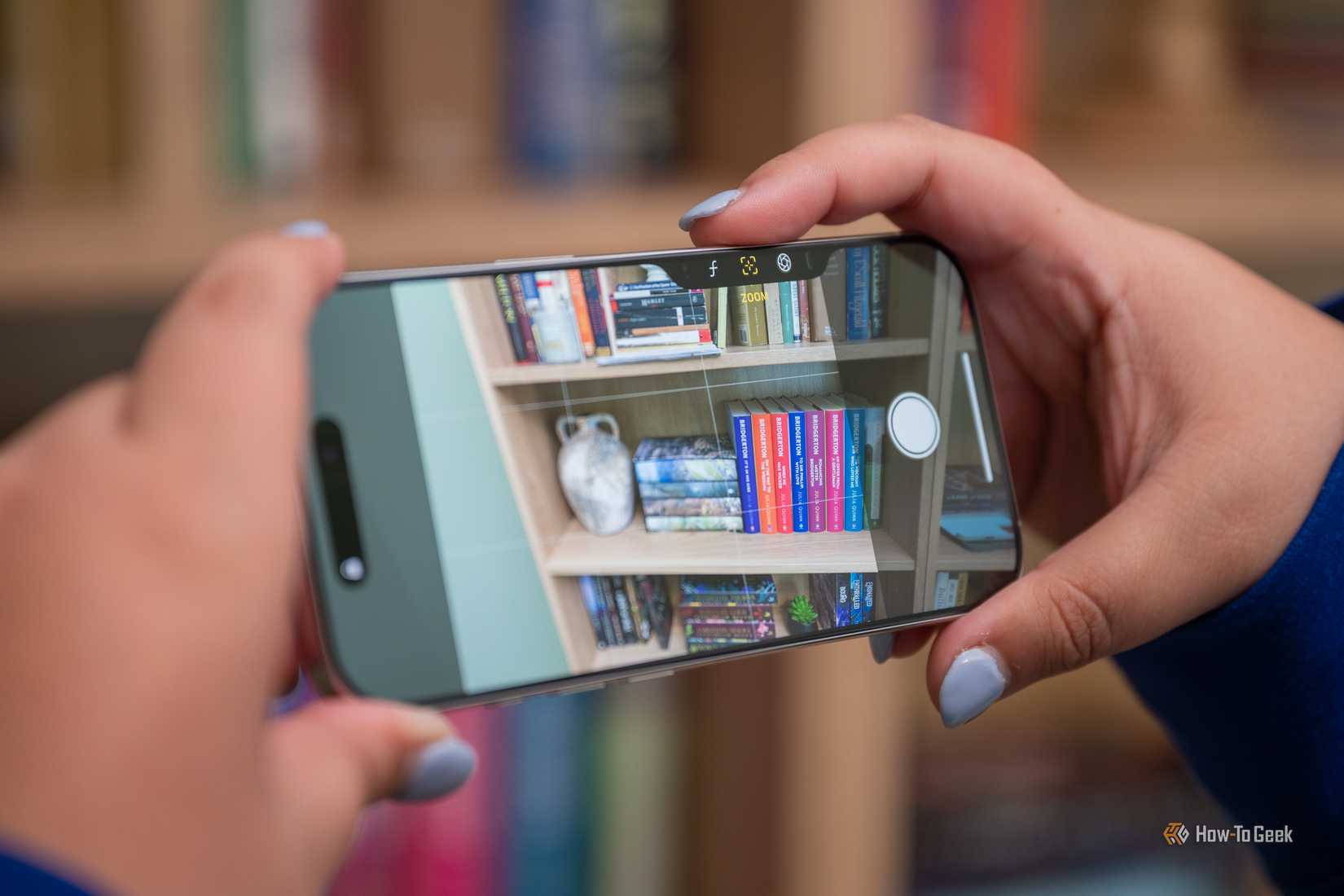 Person taking a picture with the Apple iPhone 16 Pro Camera Control button in landscape.