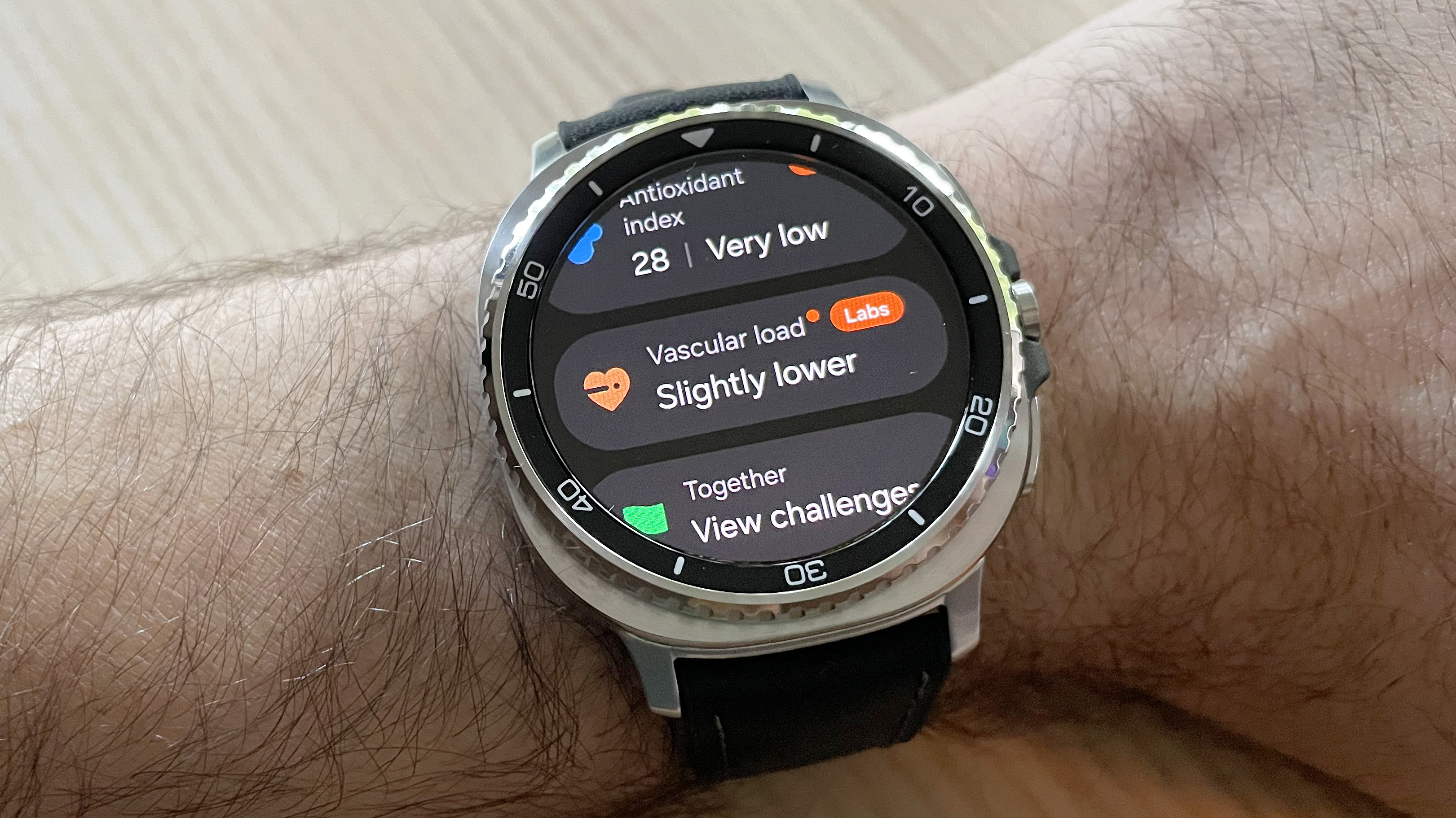 Close-up of the Samsung Galaxy Watch 8 Classic in silver on a black strap showing health data