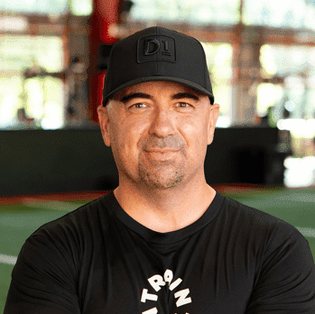 Headshot of man wearing black cap and black T-shirt