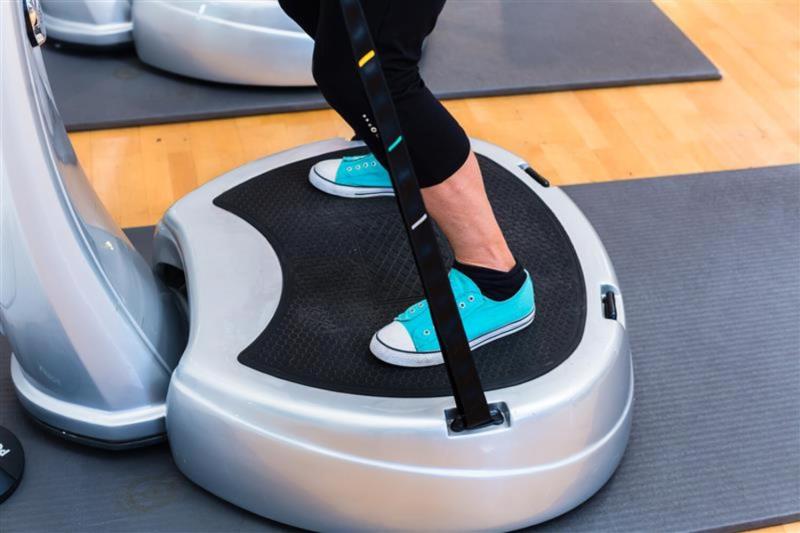 Person standing on vibration plate.