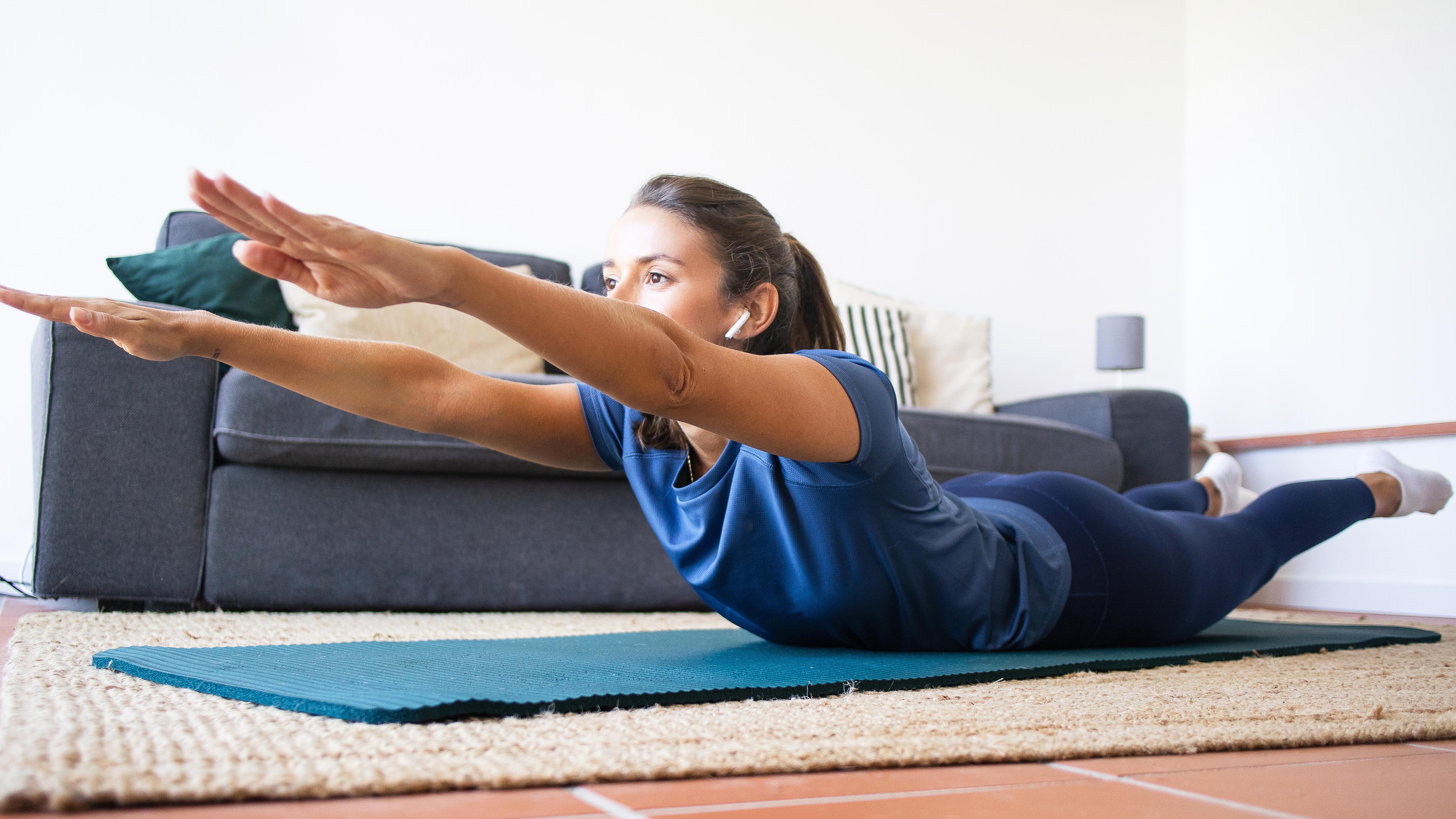 a woman doing the superman exercise