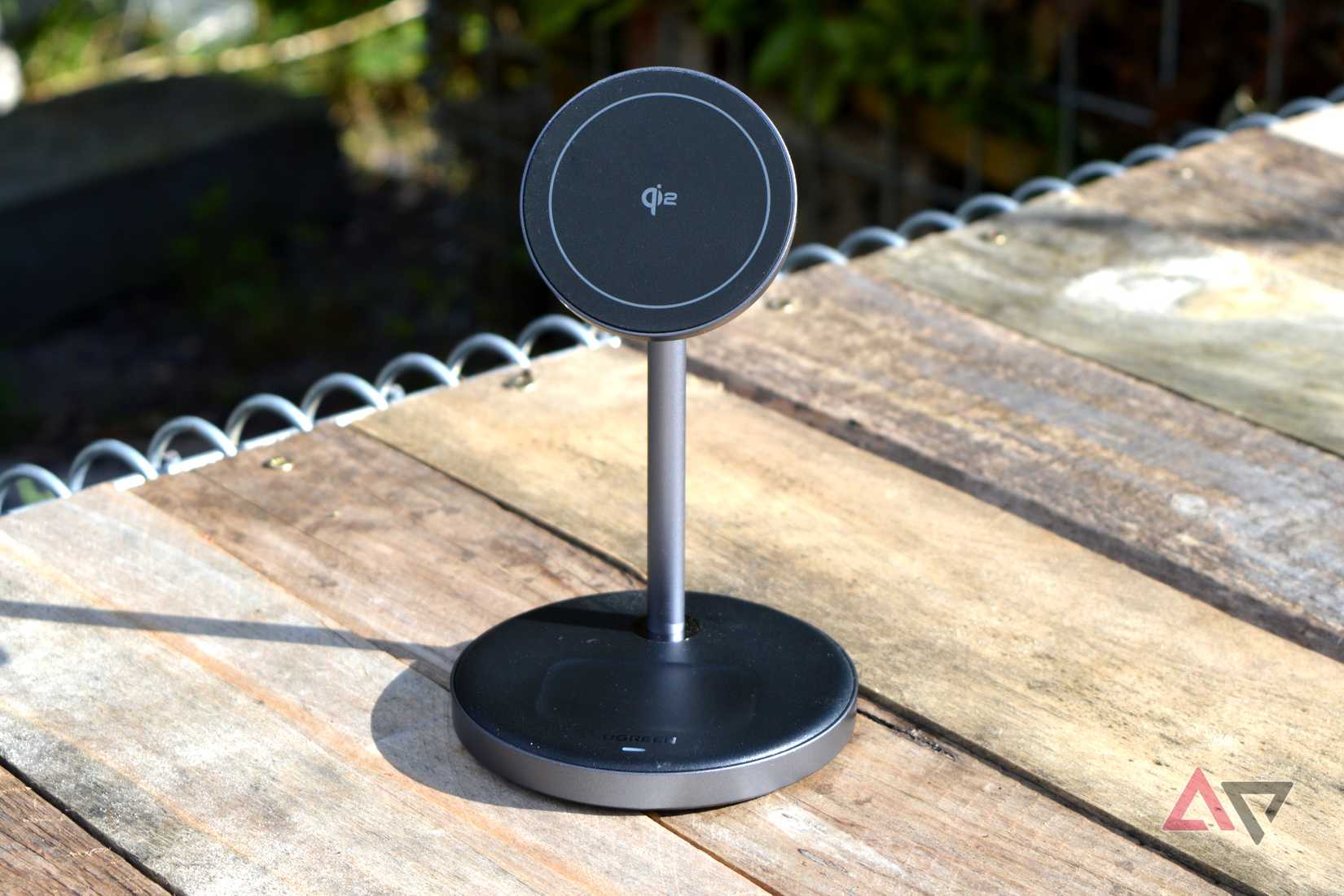 The Ugreen Qi2 stand outside on a bench.