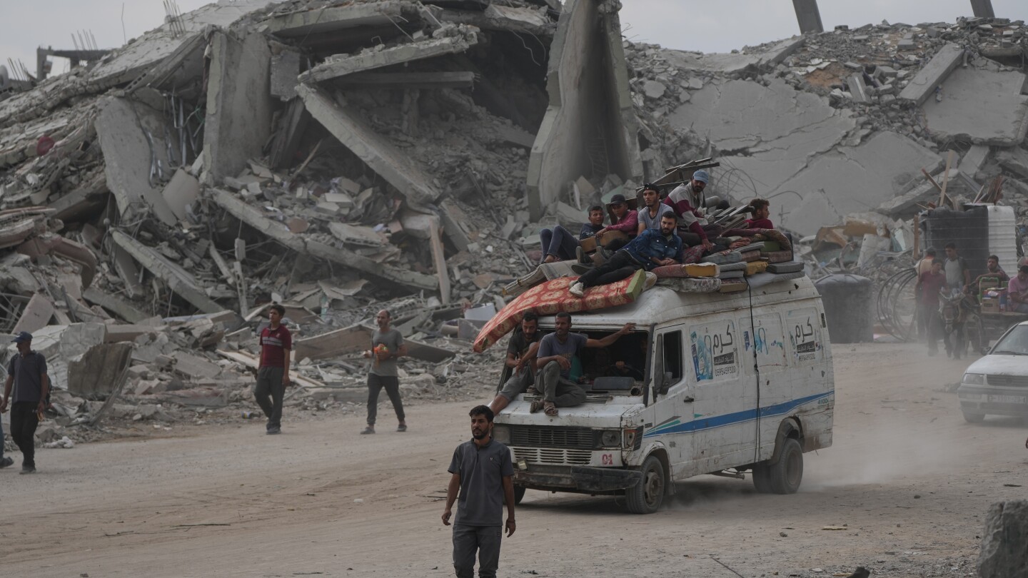 The Latest: Palestinians journey back home as aid convoys enter Gaza and truce holds