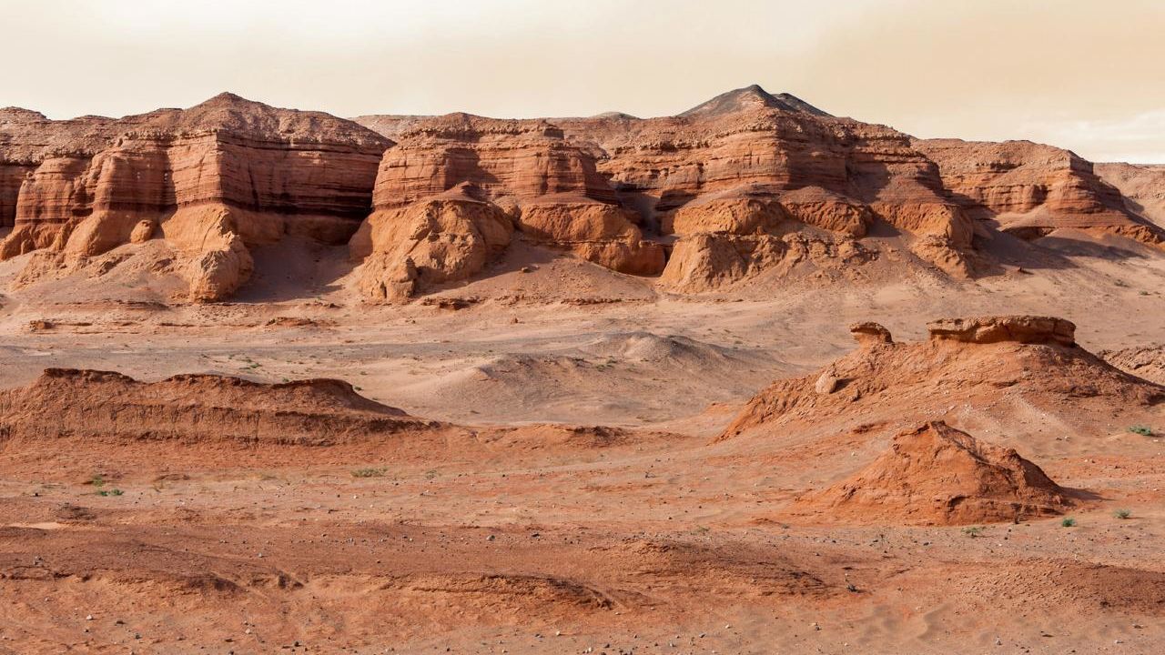 The Gobi Desert: Its soil is rich in iron oxide, giving the soil a reddish hue, similar to the Martian landscape.