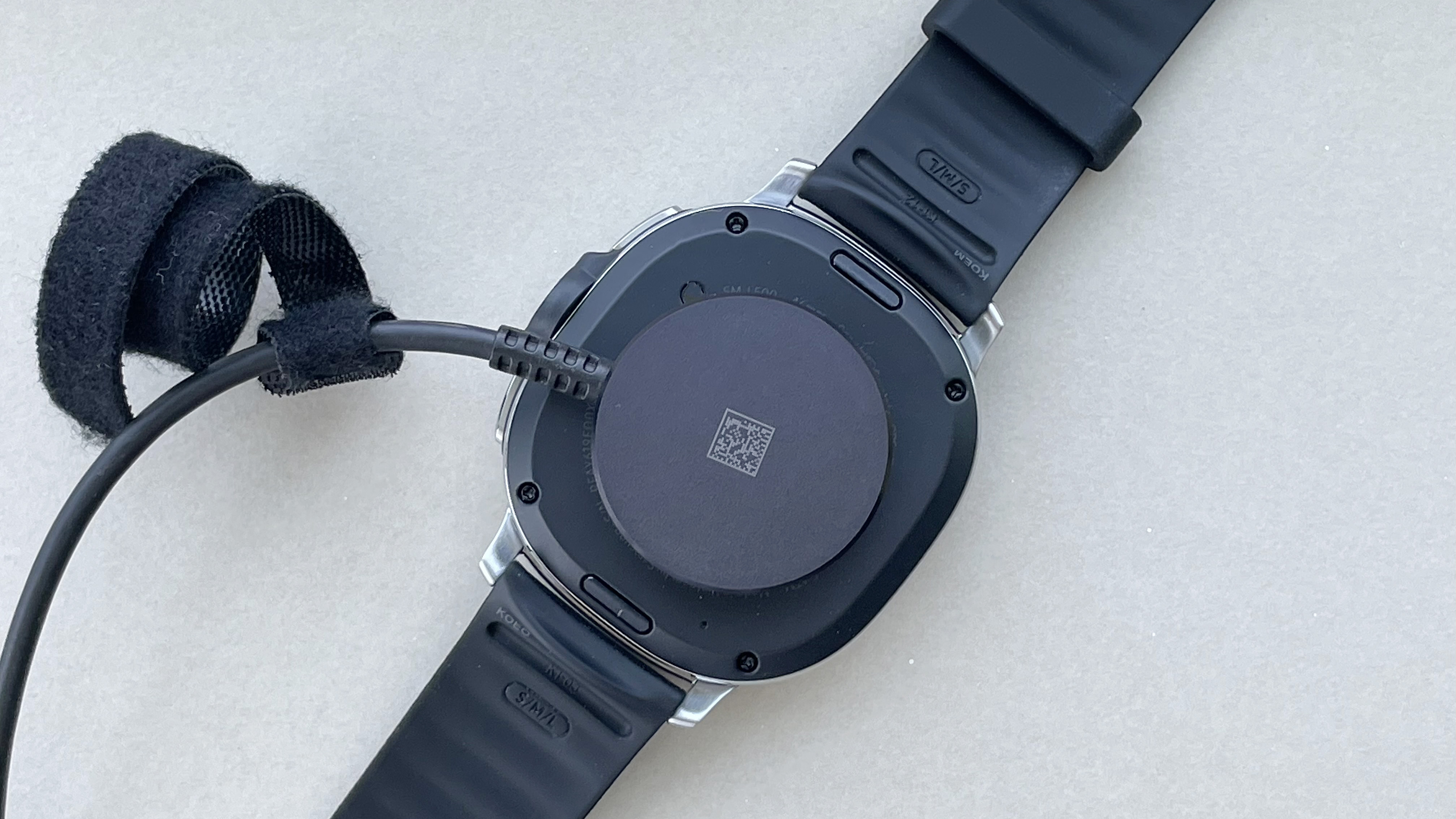 Close-up of the back of the Samsung Galaxy Watch 8 Classic showing the charger connected