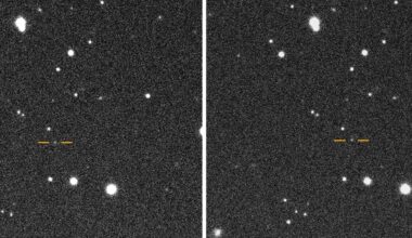 a white blurry dot on a black starry background