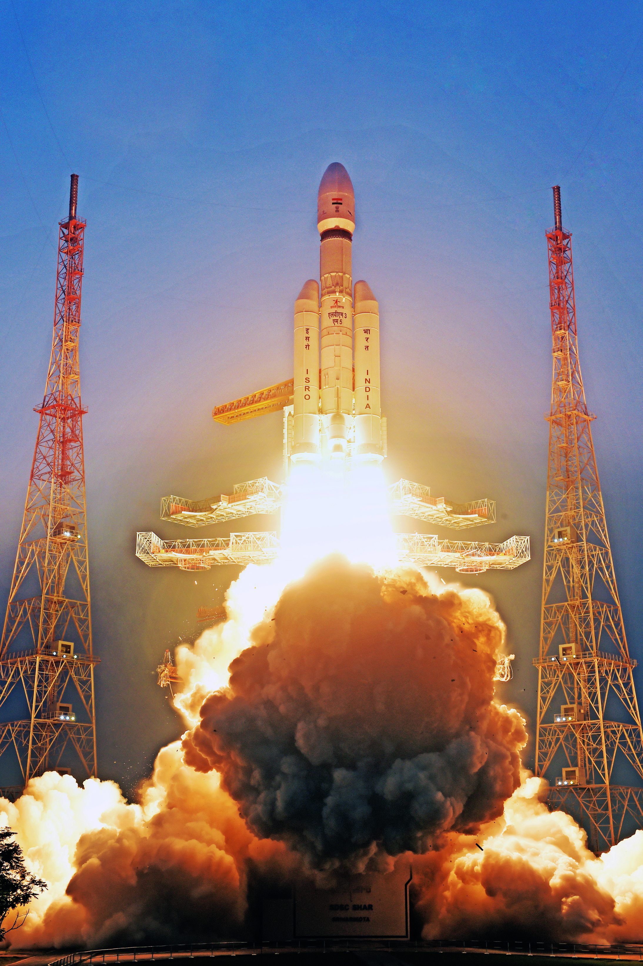 ISRO's LVM3-M5 launch vehicle lifts off, carrying the CMS-03 communication satellite, with a large cloud of smoke and fire at its base.