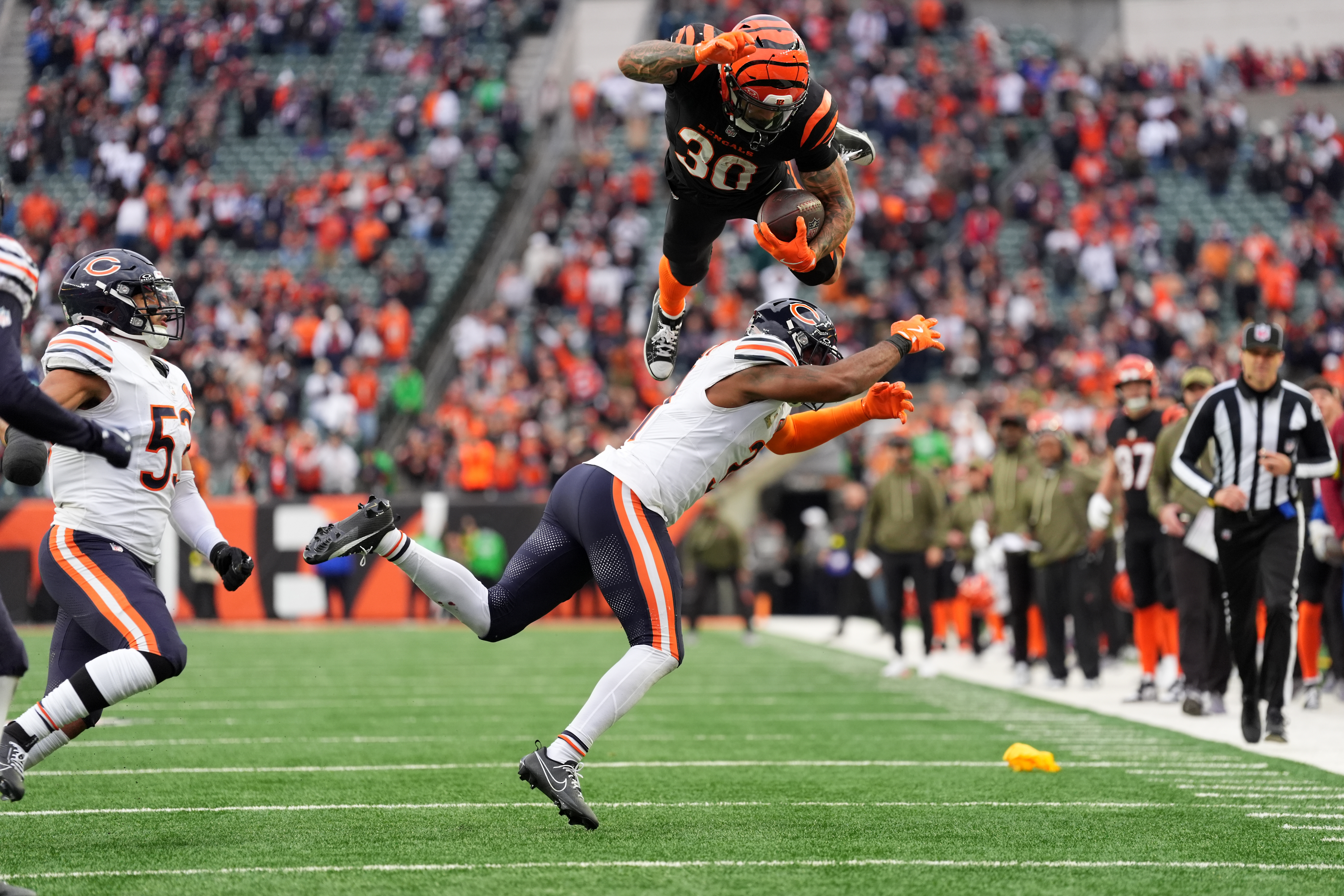 Cincinnati Bengals running back Chase Brown (30) hurdles Chicago Bears defensive back Kevin Byard III (31).