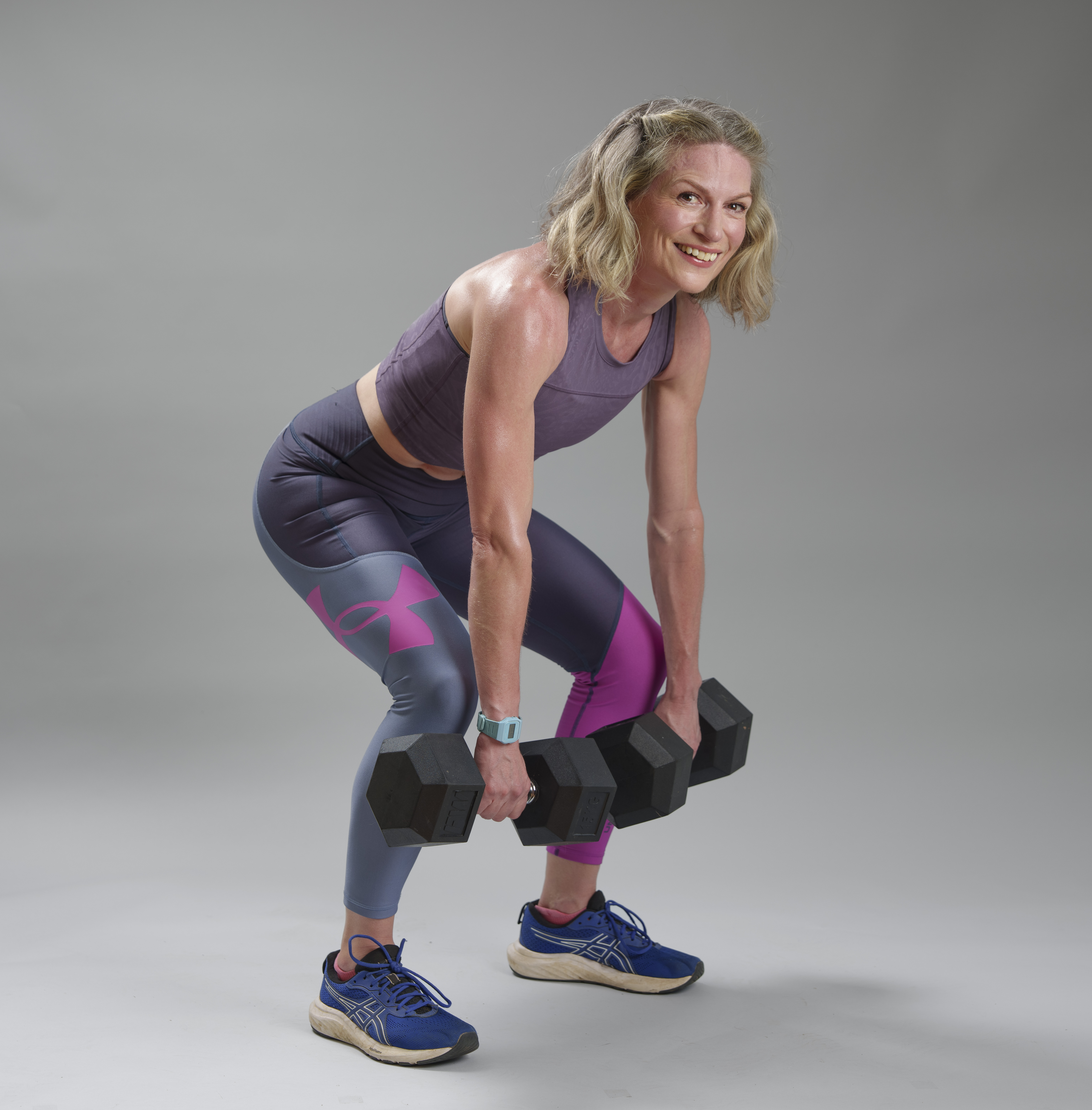 Antonia Hoyle performing a deadlift with dumbbells.