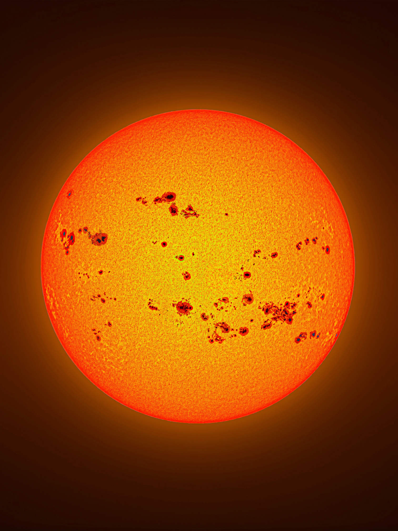 Collage of the Sun covered in dozens of large dark sunspots, stitched together over two years to show its activity during a solar maximum.