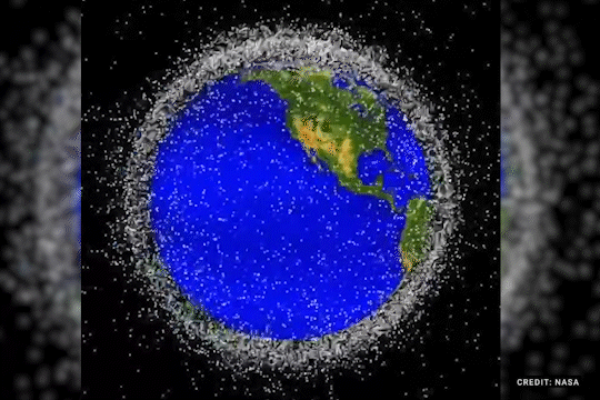 Illustration of Earth surrounded by a thick band of space debris.