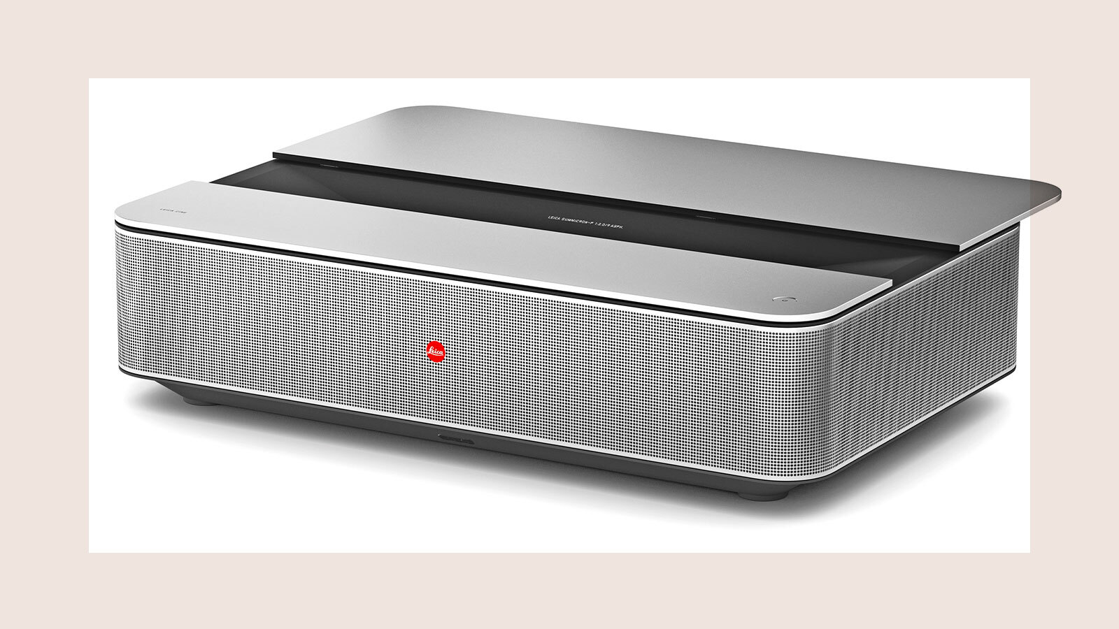 A silver projector with a perforated speaker grill.