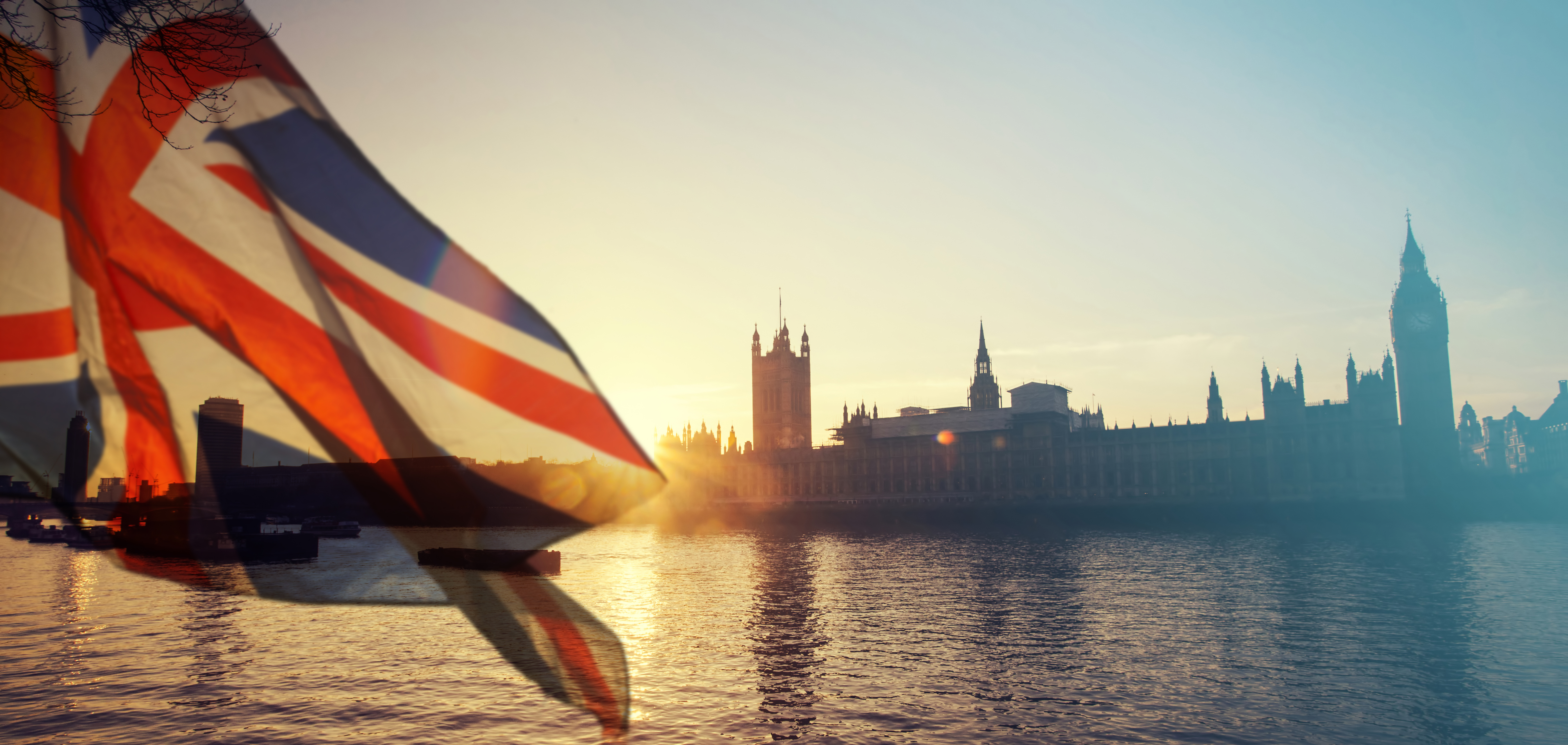 UK flag and Big Ben at sunset.