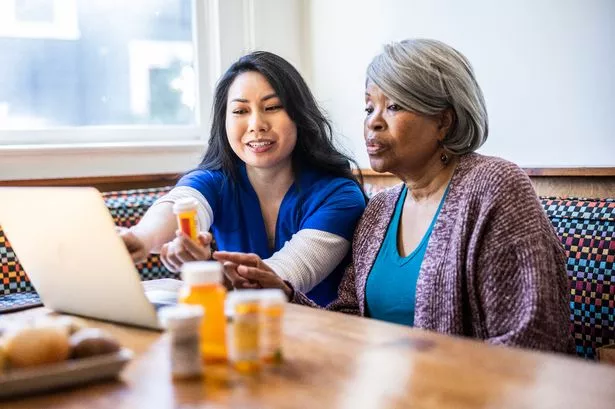 Senior woman having in-home consultation with nurse