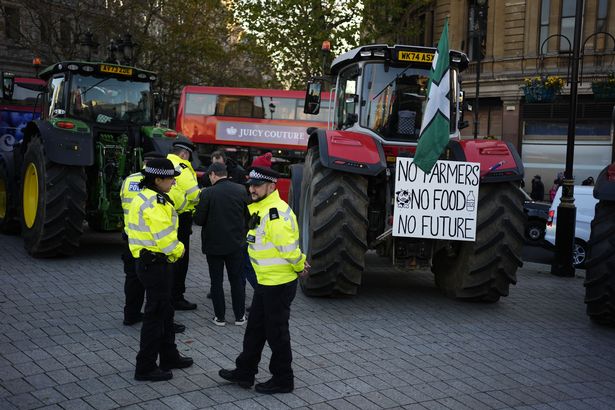 Police officers speak to farmers taking part in the protest 