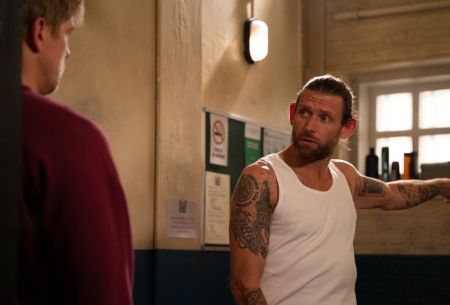 Kev stares at Robert who has entered his cell in Emmerdale