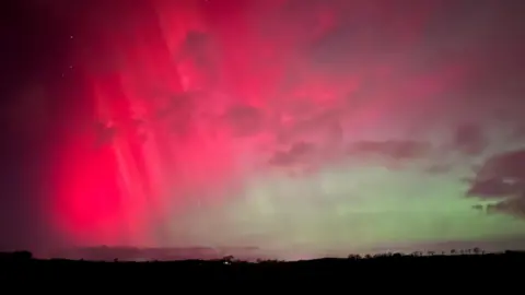BBC weather watcher / Johnny The Northern Lights lighting up the sky in shades of green and pink. 