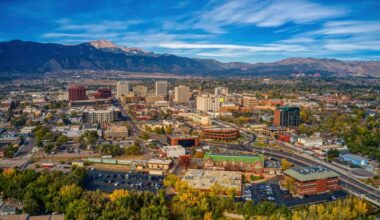 Aerial picture of the overhead view of Colorado springs with building and trees with autumn colors.