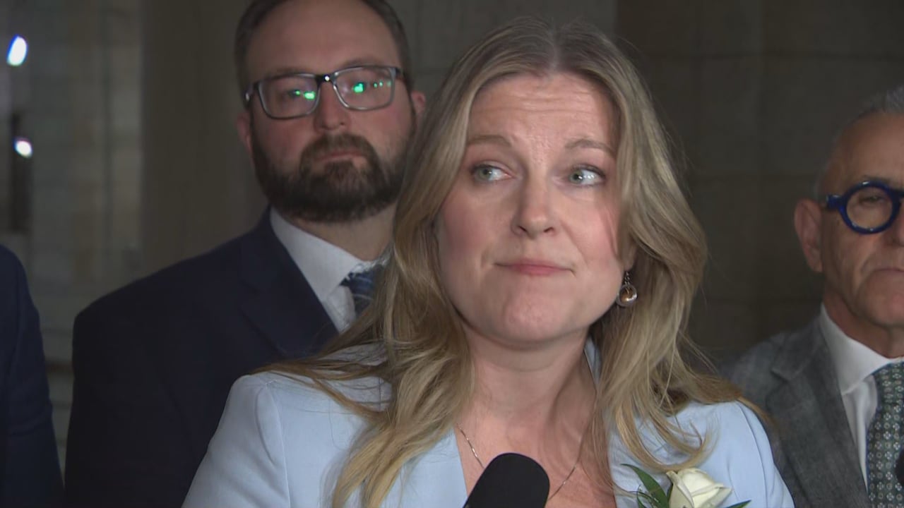 A man with blond hair in a light blue blazer