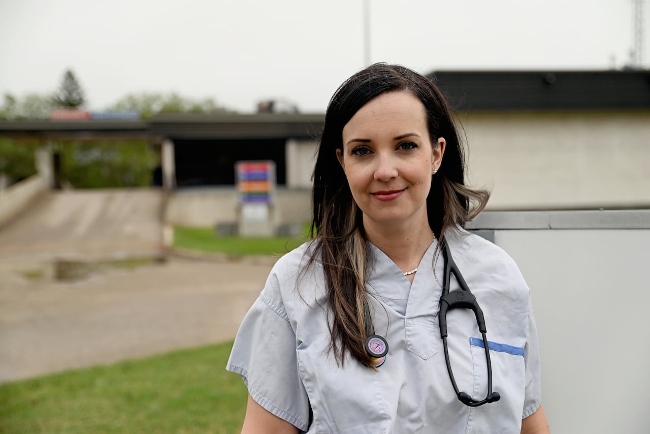 A woman wearing doctor's clothing with a stethoscope. 