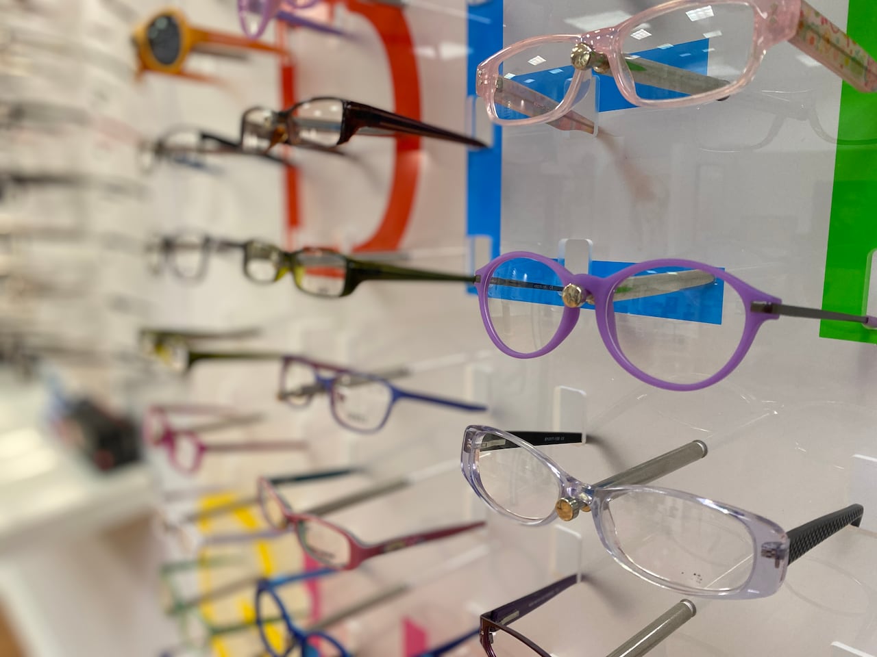 Glasses on display clips against a wall