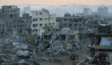 Palestinians walk past the rubble of destroyed buildings in Gaza City, Source: Vatican News
