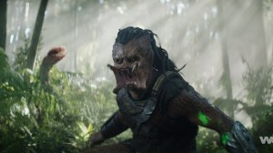 Still of Dek (Dimitrius Schuster-Koloamatangi) snarling in the forest in 'Predator: Badlands'