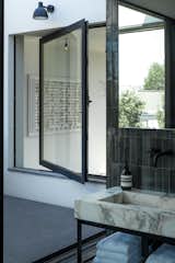 The choice of eye-catching Brescia Verde marble elevates the home design above the office spaces.