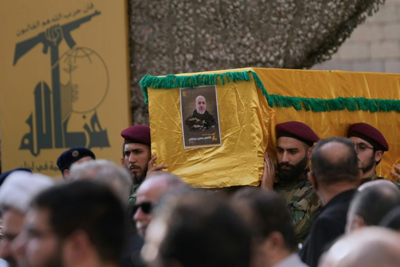 Men carry coffin of military leader.