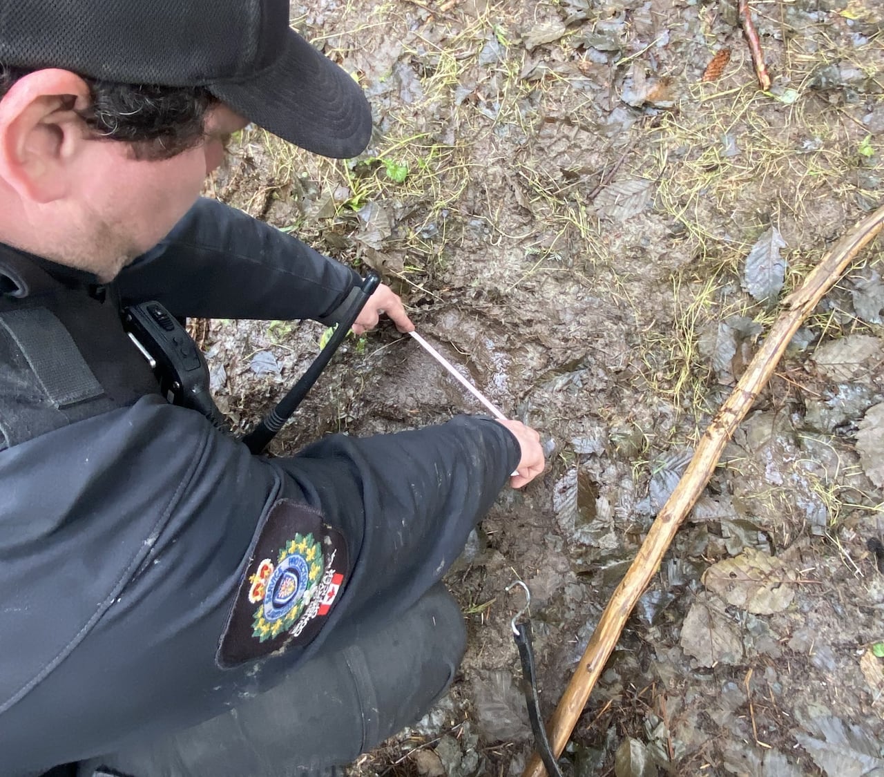 man crouched down taking measurements on the ground