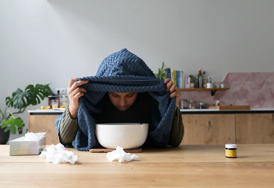 A young woman at home, feeling sick.