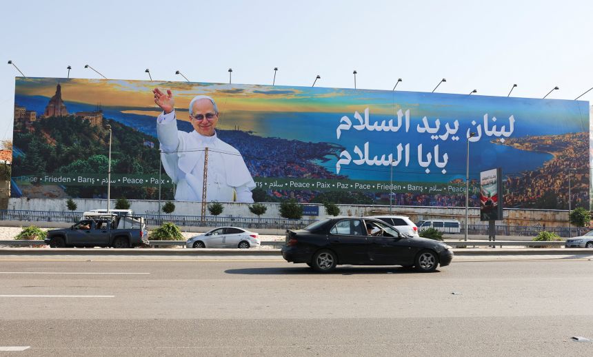 A car drives near a billboard depicting Pope Leo XIV in Beirut ahead of his planned visit to Lebanon.