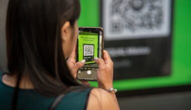 A woman uses her phone to read a QR code with the Camera app.
