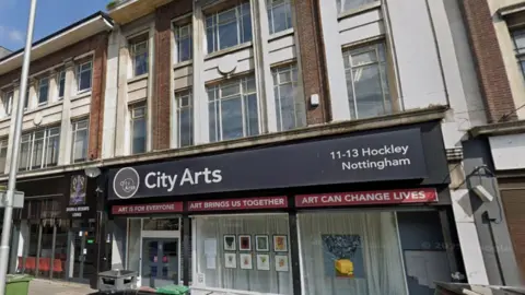 Google Streetview image of the City Arts building, a large glass frontage set in a three-storey brick building on a city street