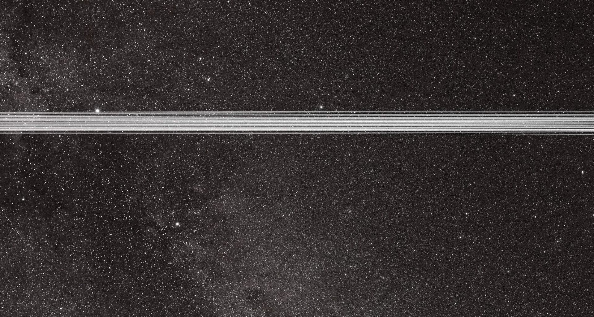 Streaks of light from Starlink satellites cross in front of the Lyra and Cygnus constellations.