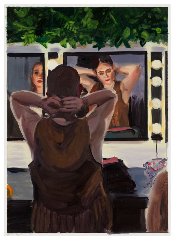 Individual preparing or styling their hair in front of a mirror.