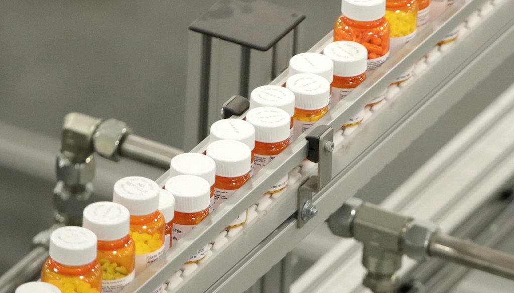 Bottles of medications ride on a belt at a mail-in pharmacy warehouse in Florence, N.J. on July 10, 2018.