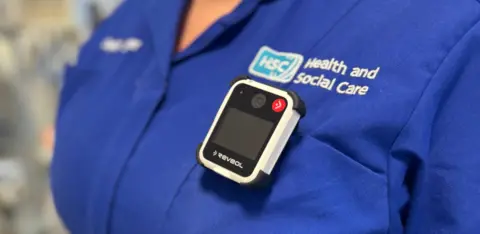 Northern Trust Close shot of a body camera on the pocket of a blue HSC uniform top.