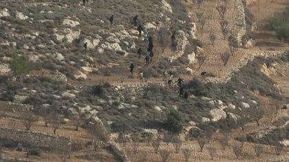 Israeli settlers descending on the West Bank village of Umm al-Butm