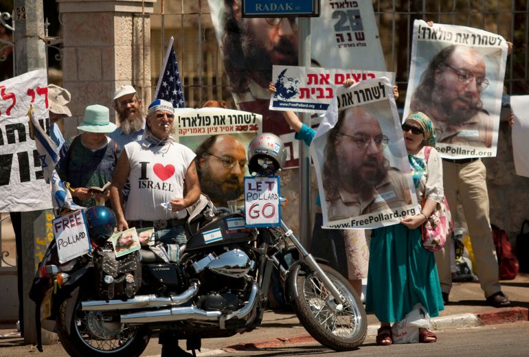 Israelis hold posters of Jonathan Pollard, who was convicted of spying for Israel during a protest calling for his release during a meeting Israel's President Shimon Peres and a delegation of 35 Republican congressmen, outside the president's residence in Jerusalem, Wednesday, Aug. 17, 2011. (AP Photo/Sebastian Scheiner)