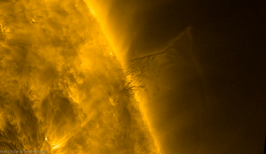 A solar prominence hovers over the Sun