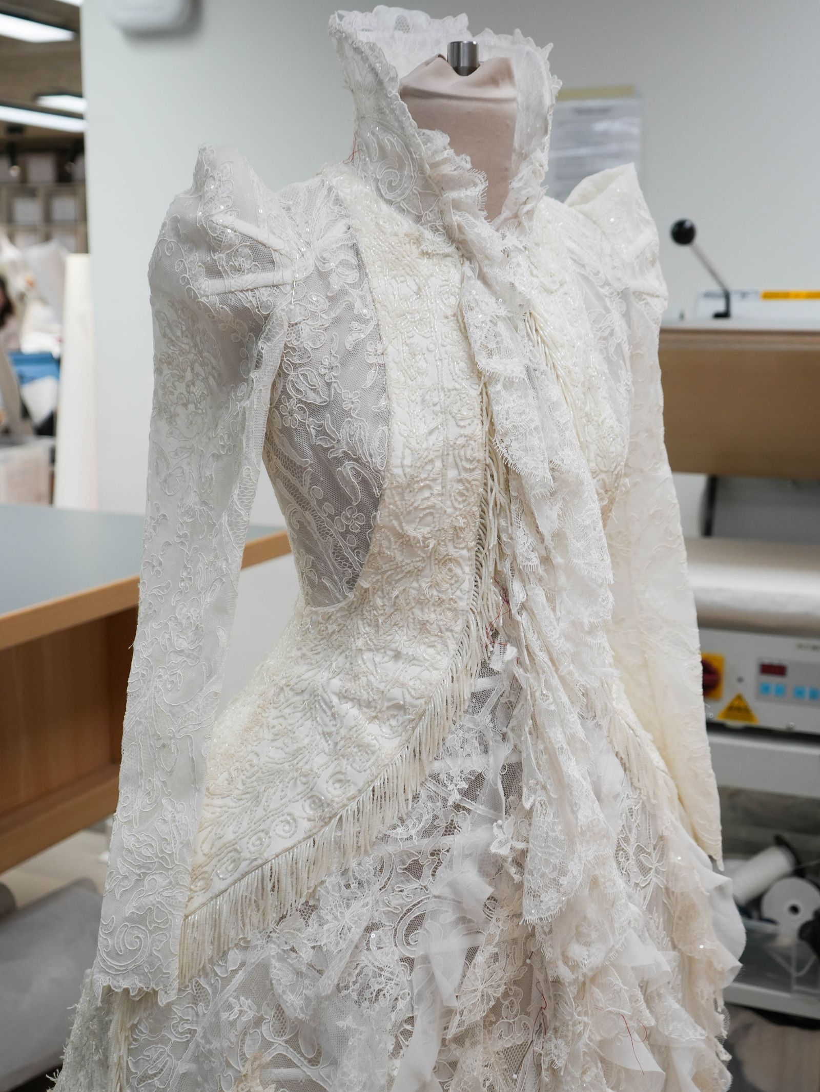 Image may contain Clothing Dress Fashion Formal Wear Gown Wedding Wedding Gown Bridal Veil Person and Lace