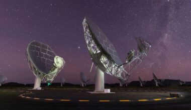 A photo of two radio dishes pointed up at the night sky