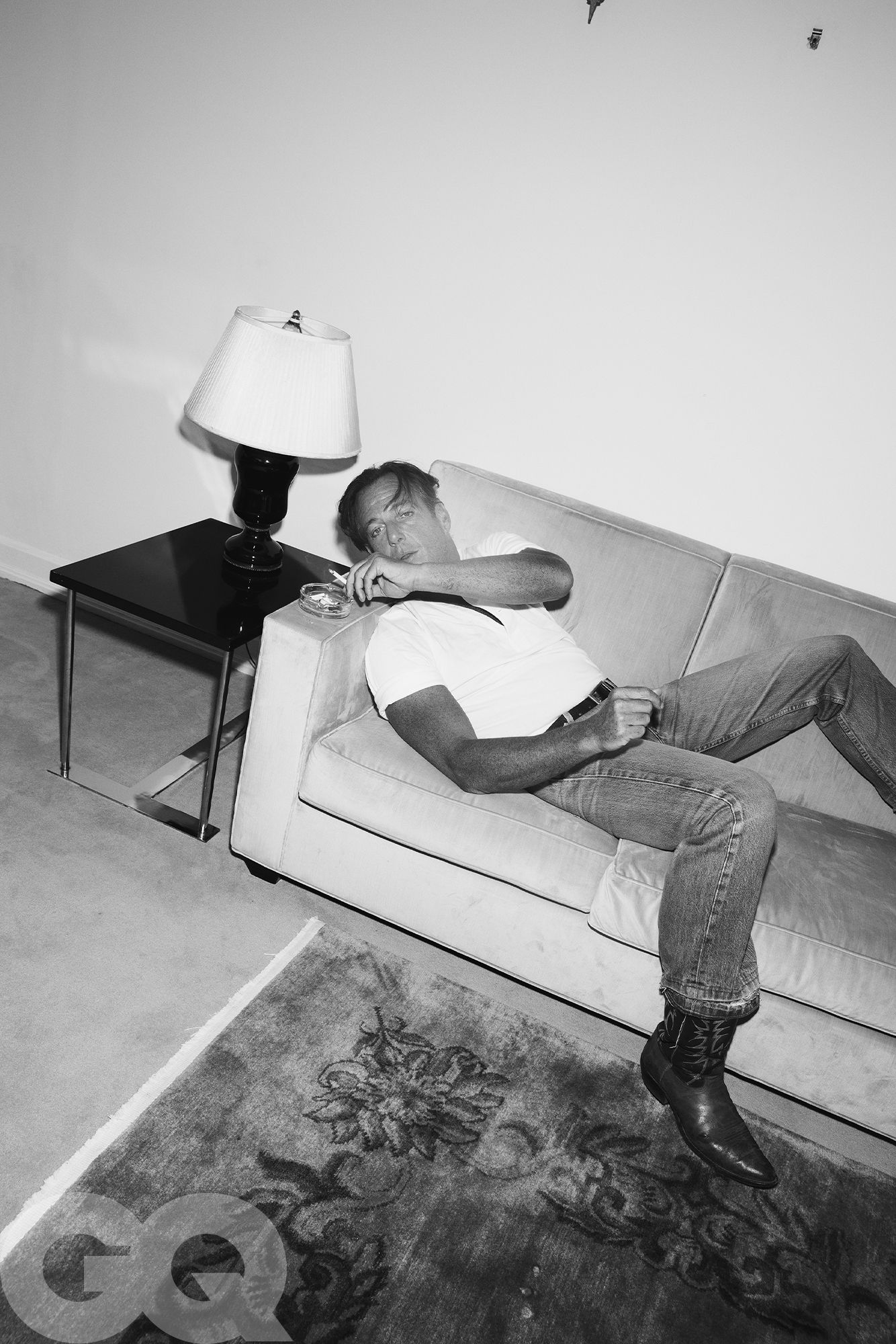 Image may contain Will Arnett Lamp Table Lamp Person Sitting Couch Furniture Head and Face