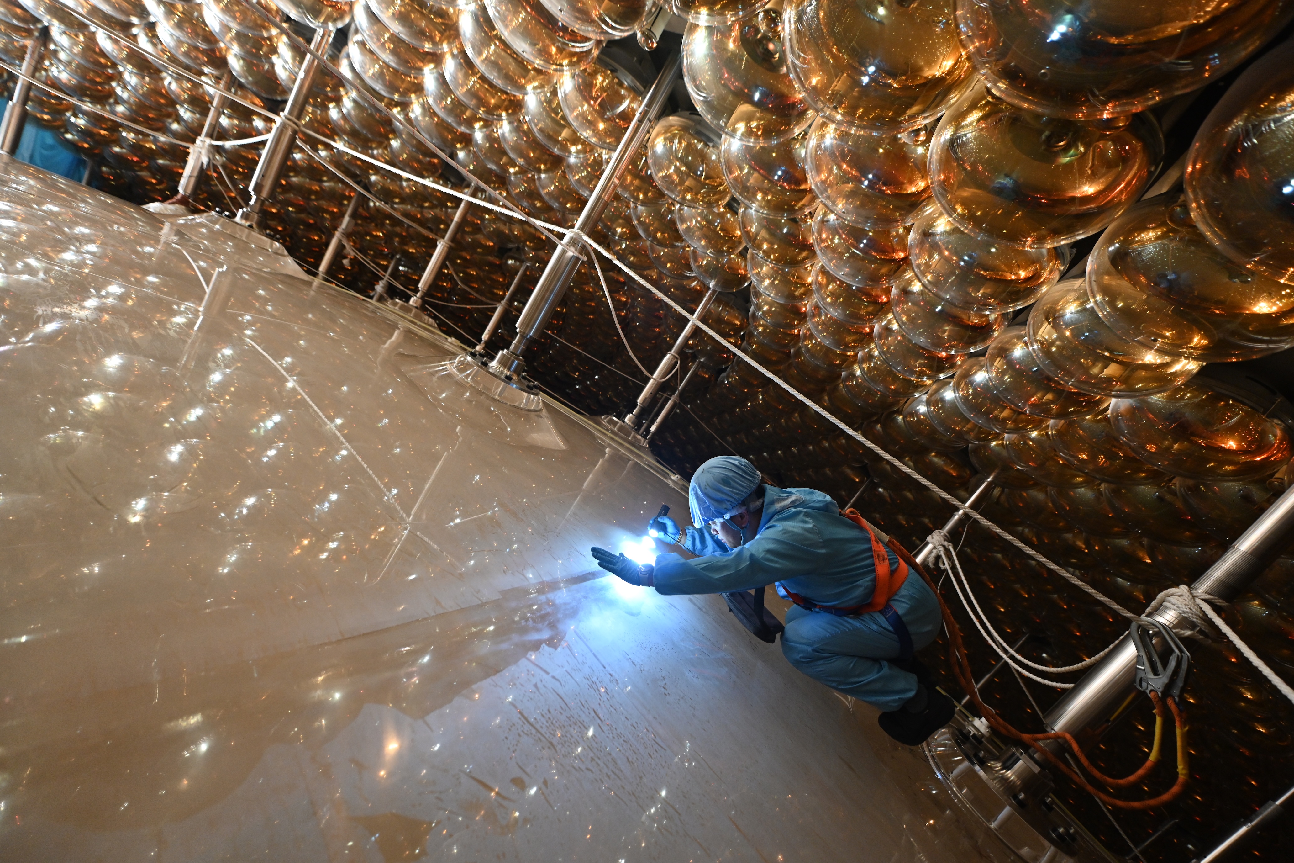 Final preparations for JUNO. Inside the white sphere is 20,000 tons of liquid which, when struck by a neutrino, produces a flash of light that is picked up by sensors surrounding the sphere.