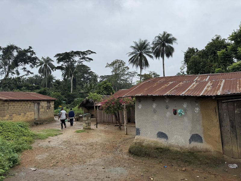 Two men walking in a village in Gorlu village, Lofa County, Liberia